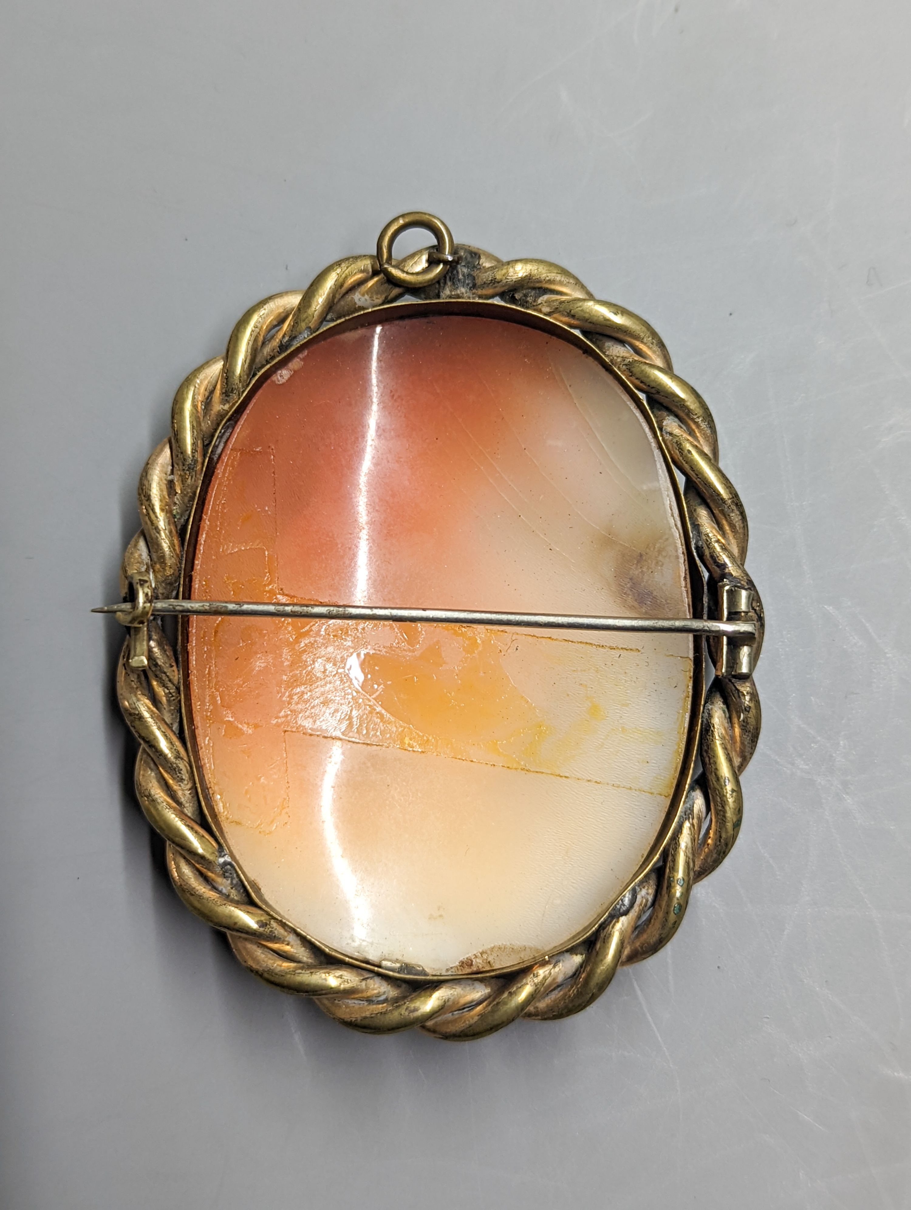 A late Victorian gilt metal mounted oval cameo shell brooch, carved with Leda & the Swan, 72mm.
